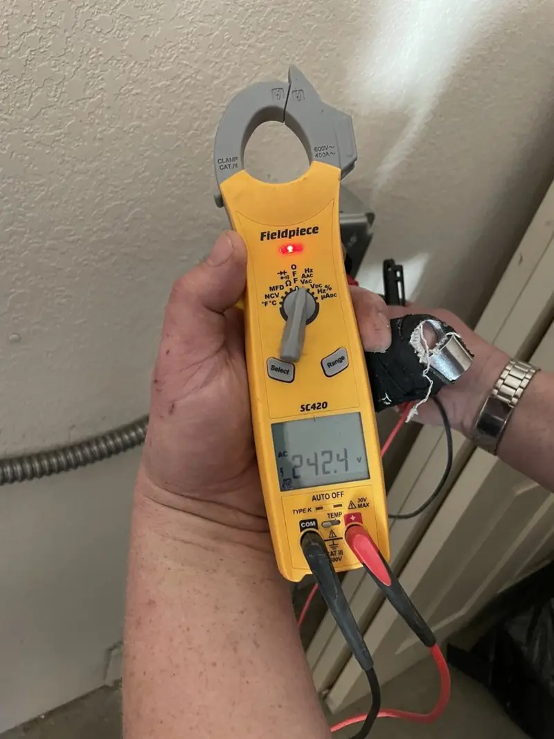 Voltage testing with clamp meter during Recessed Lighting Installation in Laguna Beach